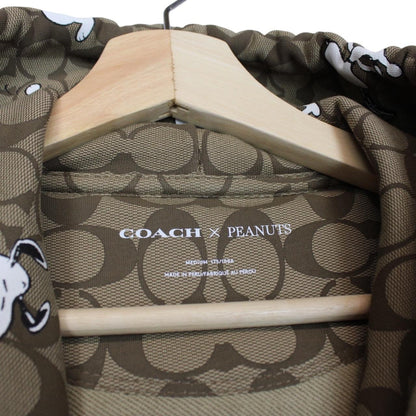 Coach brown hoodie featuring Peanuts Snoopy graphic and full zip design.