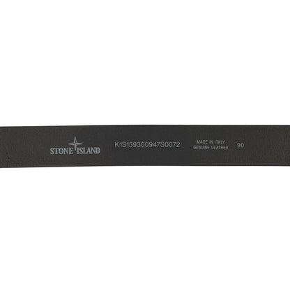 Stone Island black tumbled leather belt with debossed Compass logo and textured metal buckle.