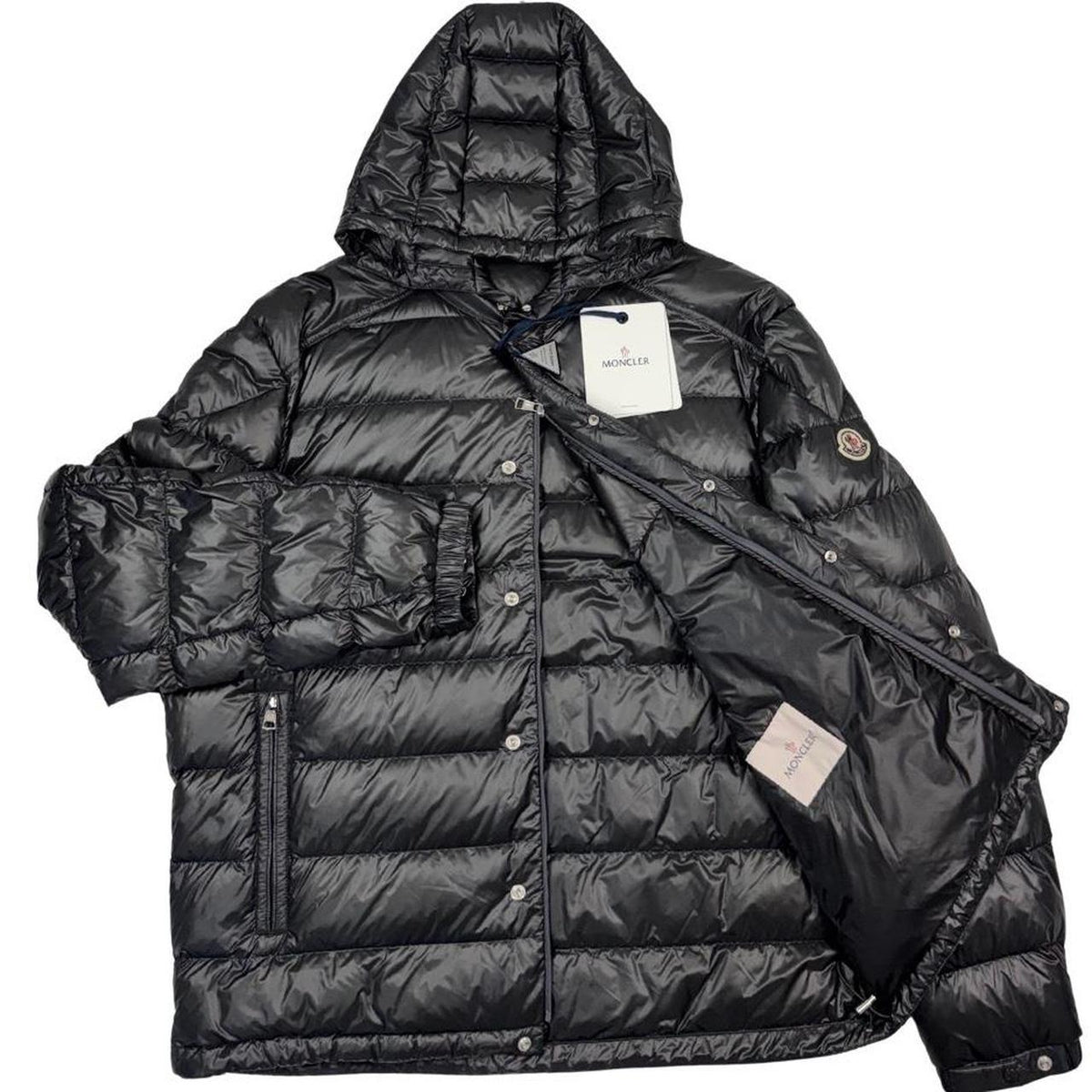 Moncler grey down nylon hooded puffer jacket with logo patch and quilted design.