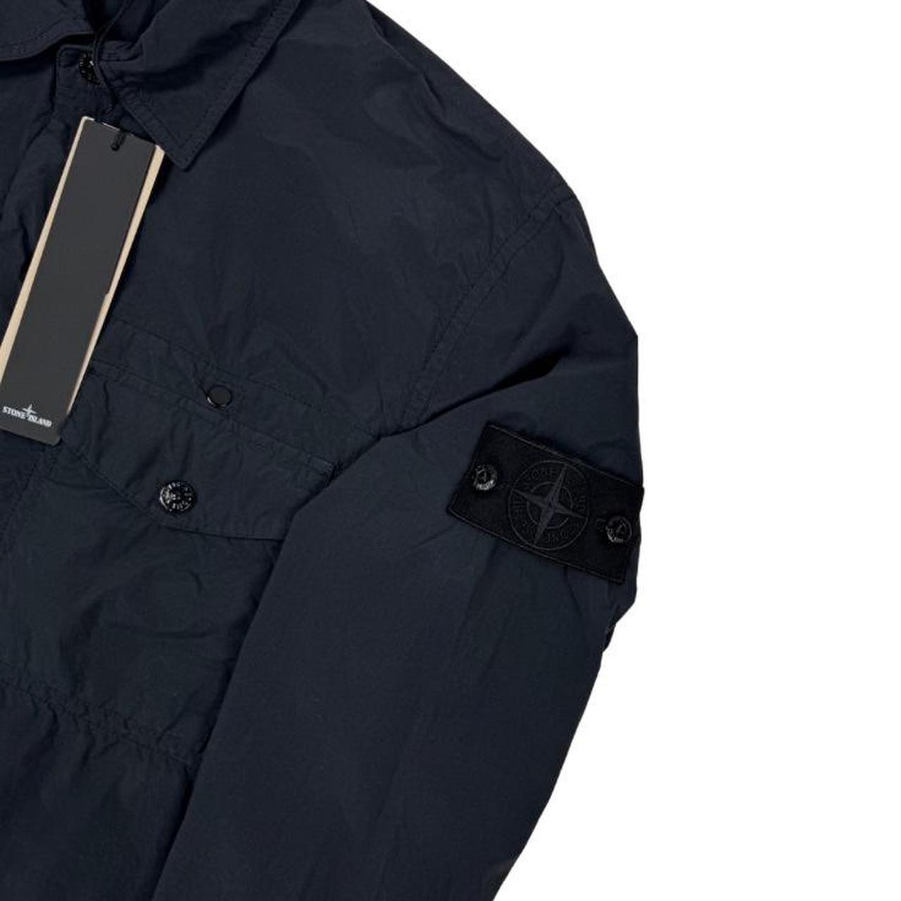 Stone Island black nylon overshirt jacket with ghost logo and smooth texture.