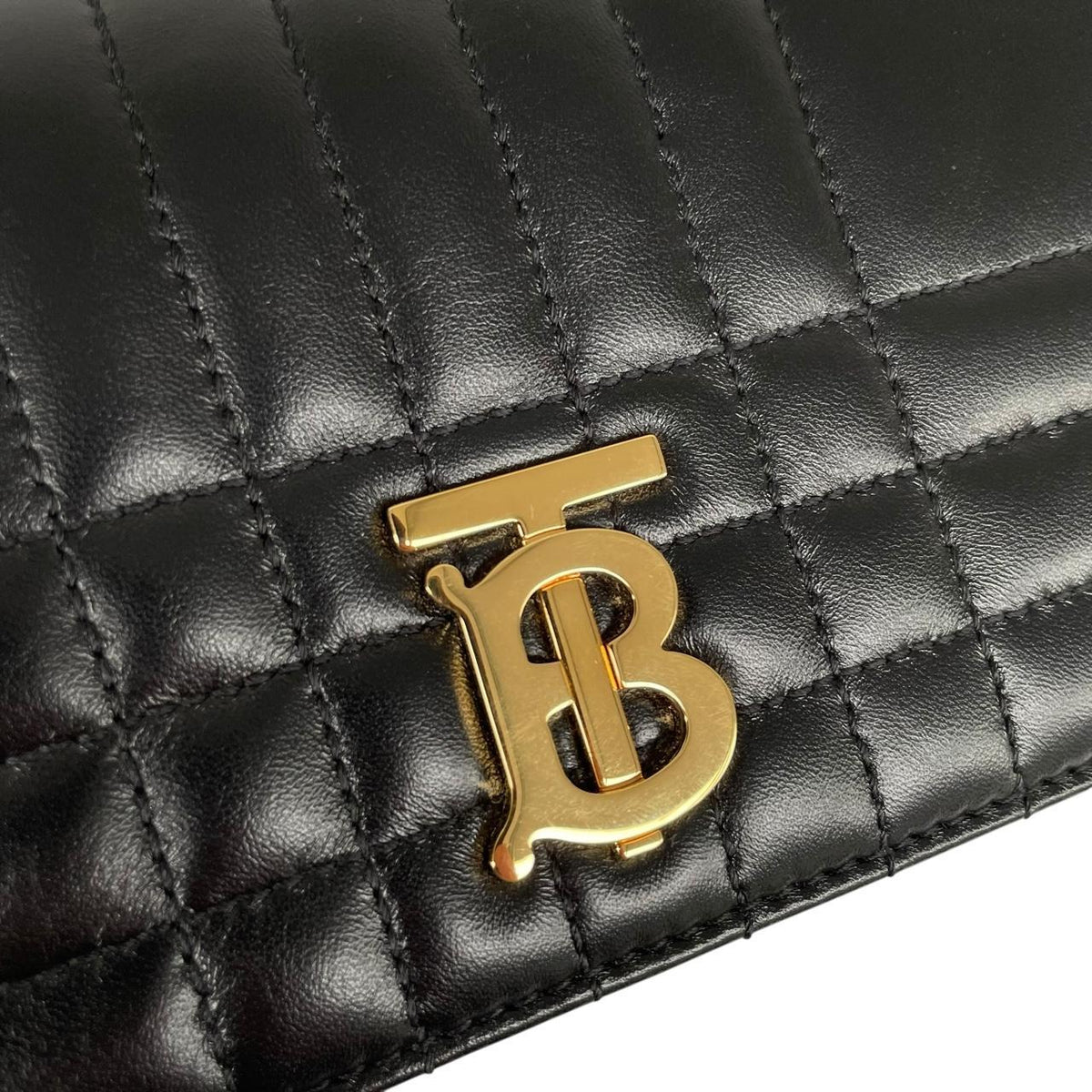 Burberry black and gold quilted leather small Lola shoulder bag with logo detail.