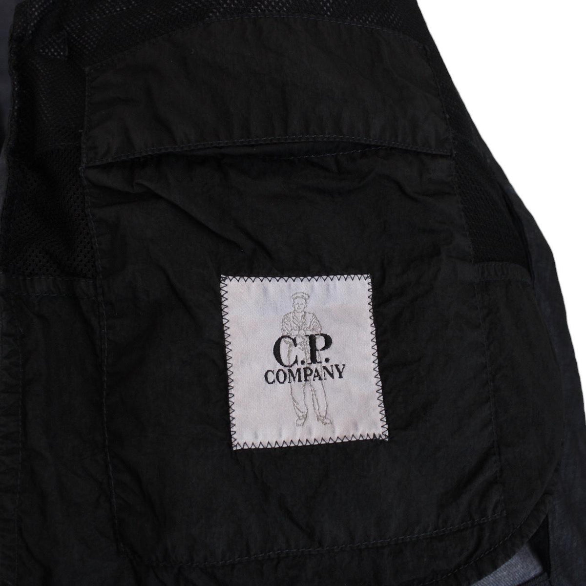 CP Company navy blue jacket garment dyed wool with logo details and gum finish.