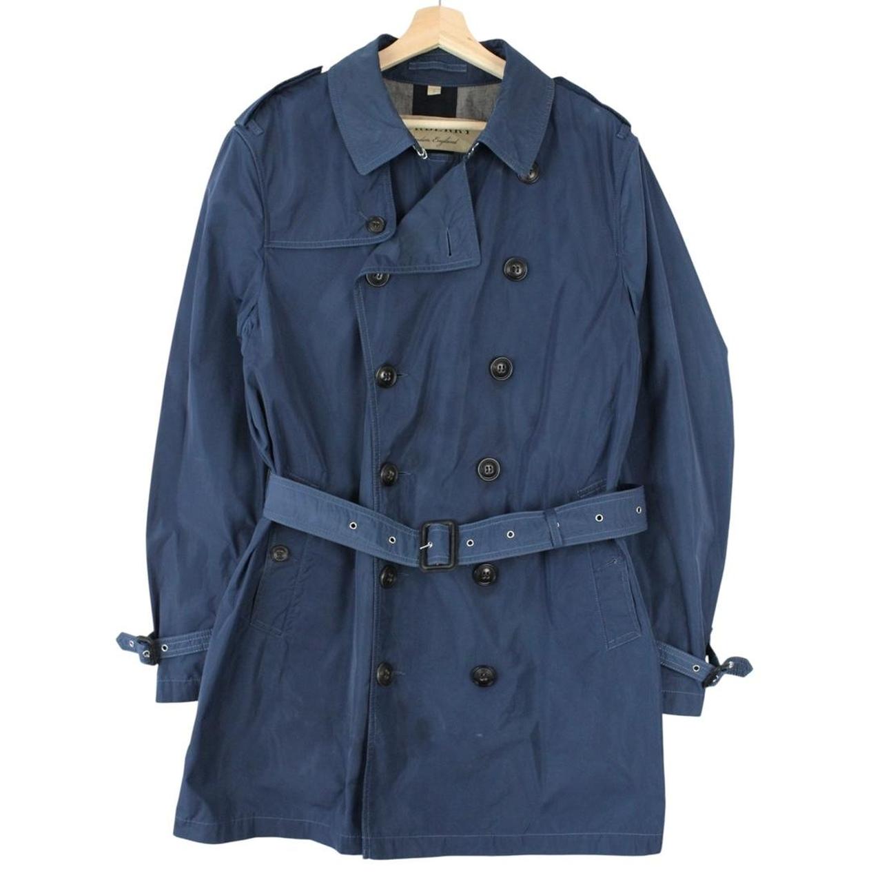 Burberry blue trench coat with Nova Check lining and belted double-breasted design.