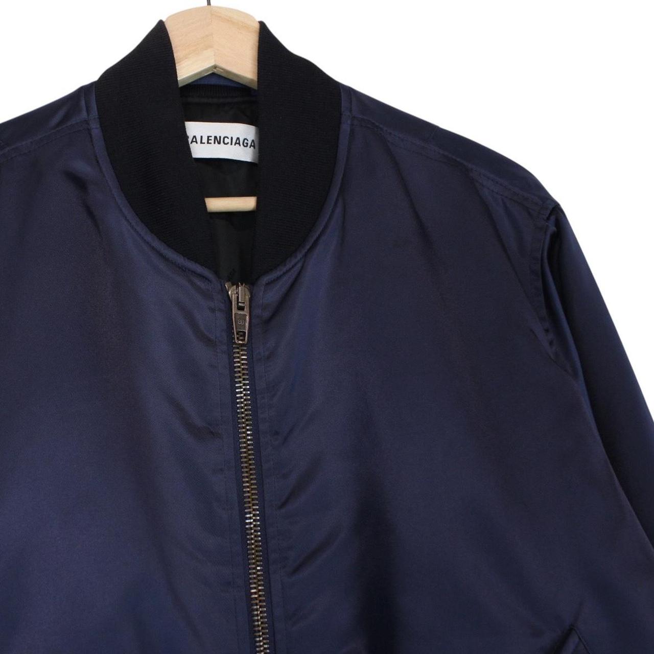 Balenciaga navy bomber jacket with full zip and campaign logo on chest.