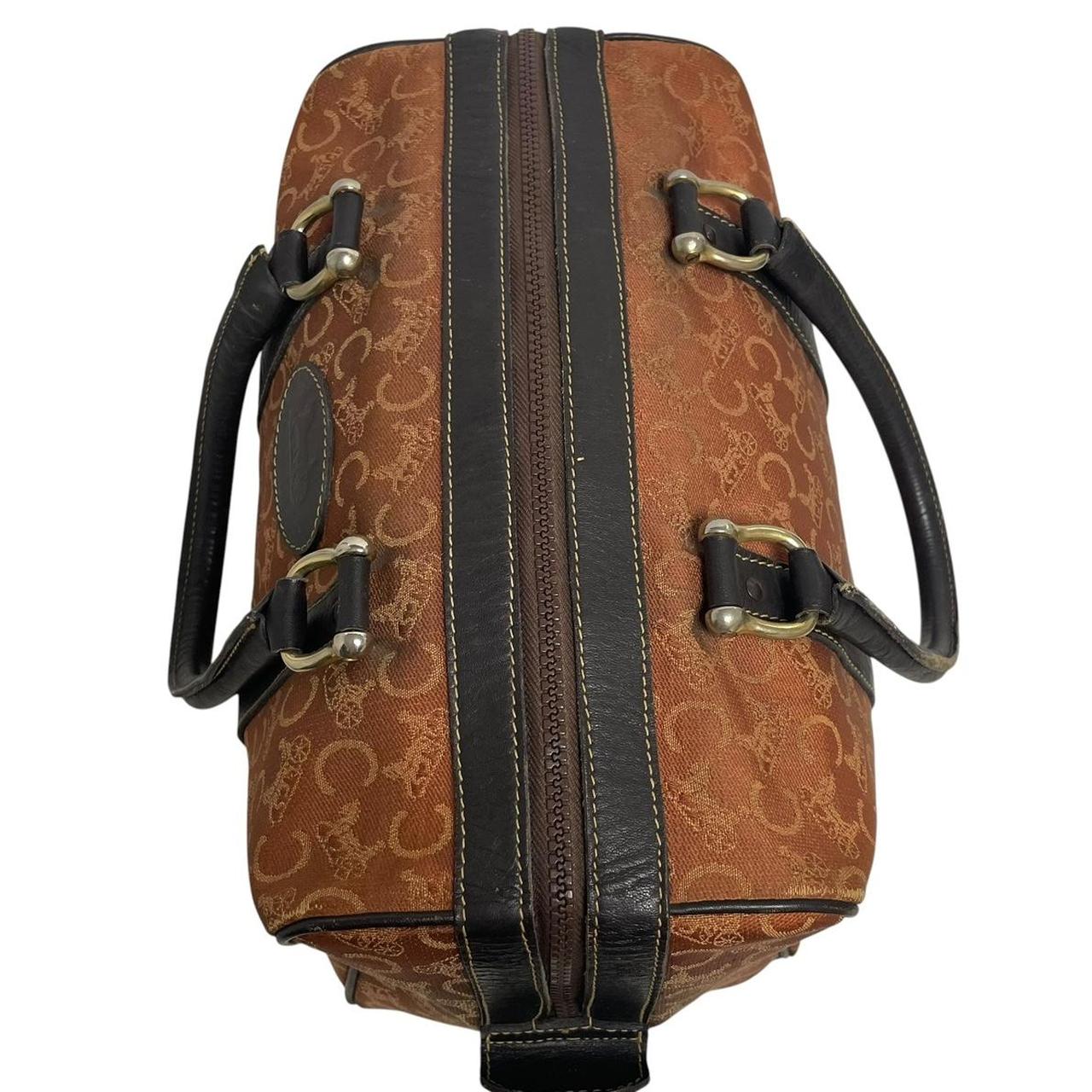 CELINE orange duffel bag with Macadam canvas and leather, visible wear and discolouration.