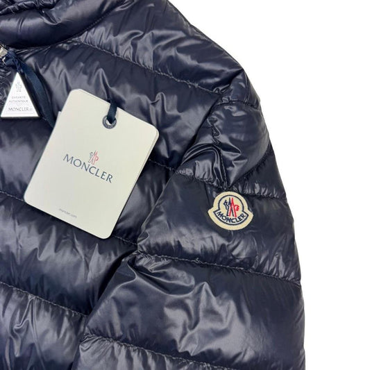 Moncler navy blue down jacket with full zip and logo patch on sleeve.