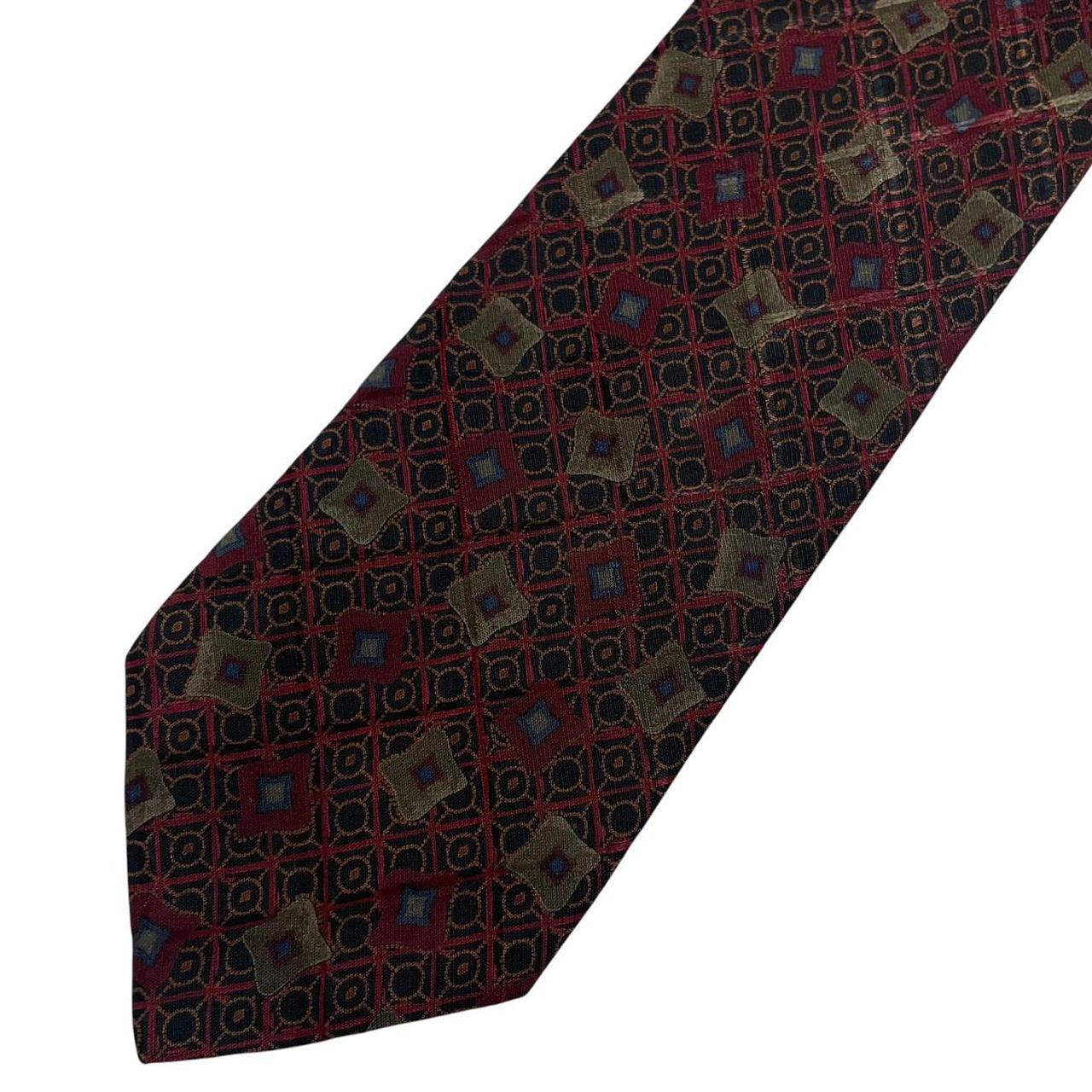 Ermenegildo Zegna burgundy silk tie with abstract print design and logo detail.