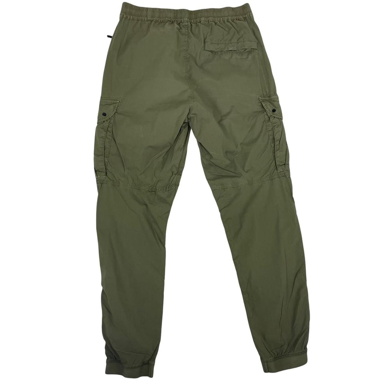 Stone Island khaki green cargo trousers with logo patch and multiple pockets.