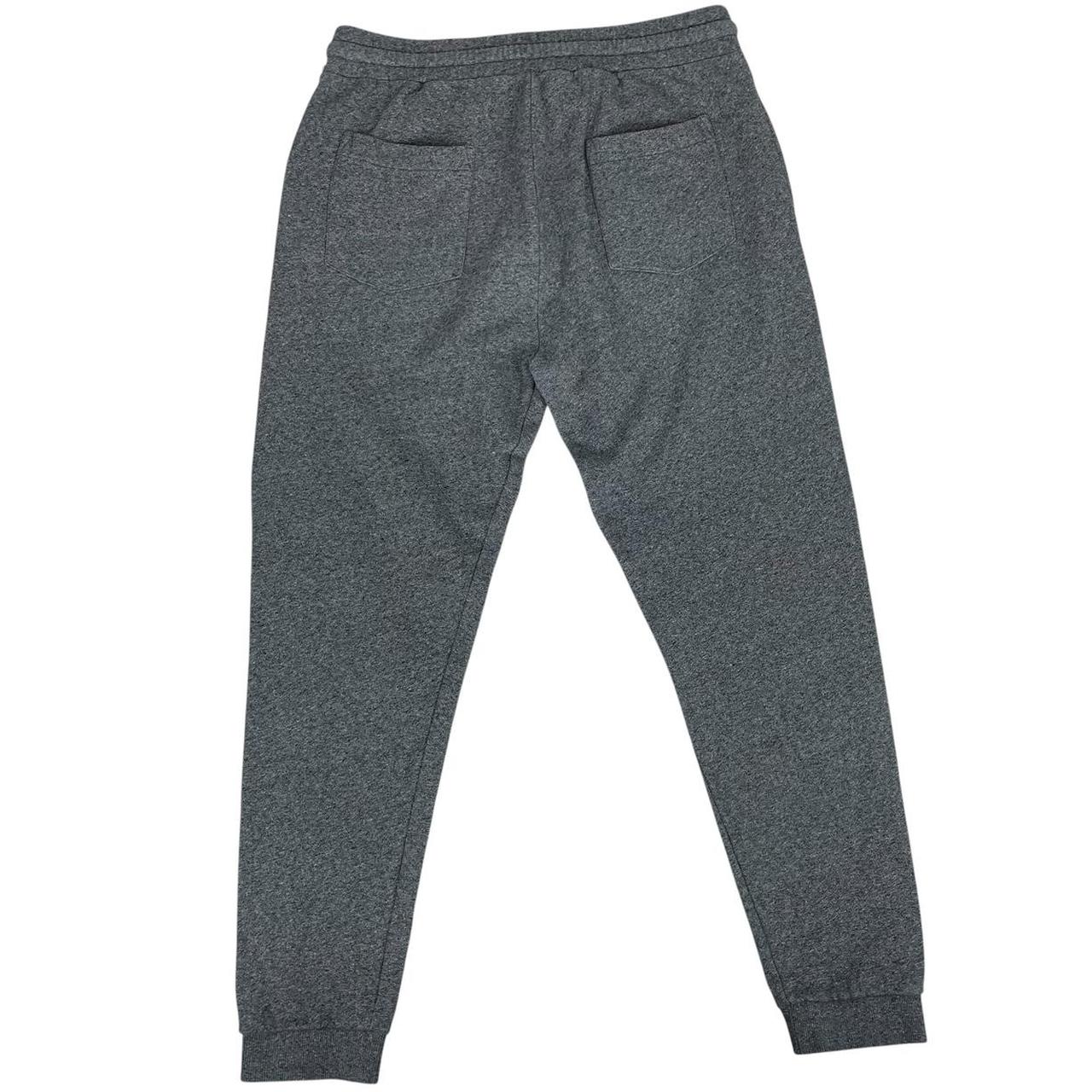Kenzo grey joggers featuring embroidered tiger logo and soft cotton material.