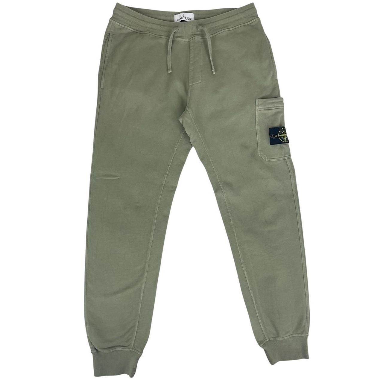 Stone Island green joggers with logo patch and cotton material, visible wear marks.