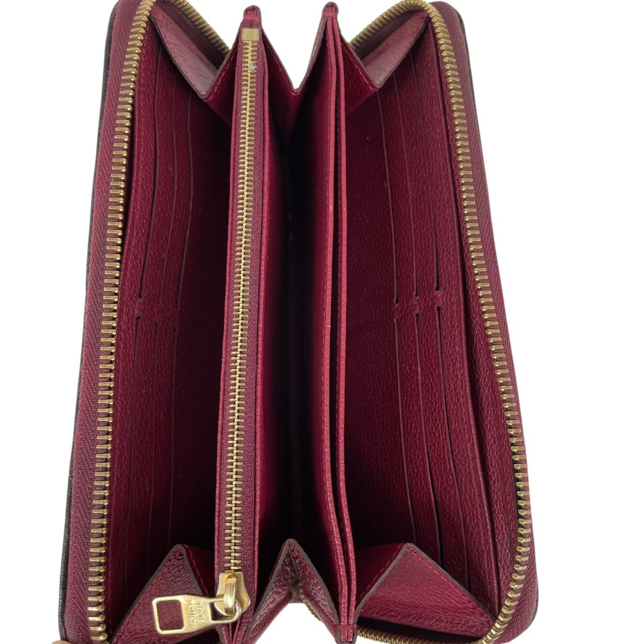 Louis Vuitton black leather wallet with monogram pattern and embossed logo.