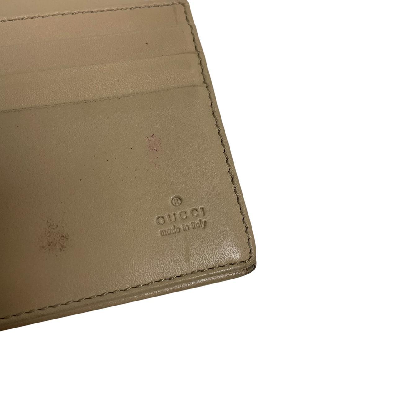 Gucci beige and pink GG monogram continental wallet with logo and wear details.