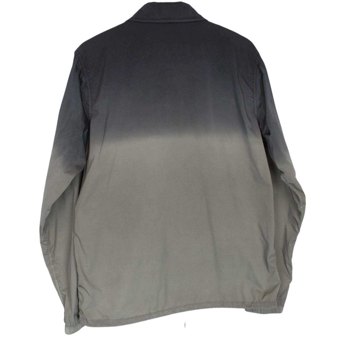 CP Company khaki green and grey jacket with shibori pattern and lens detail.