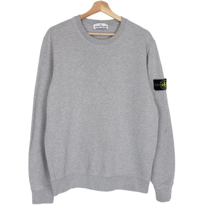 Stone Island grey cotton sweatshirt with logo patch and faint mark on sleeve.