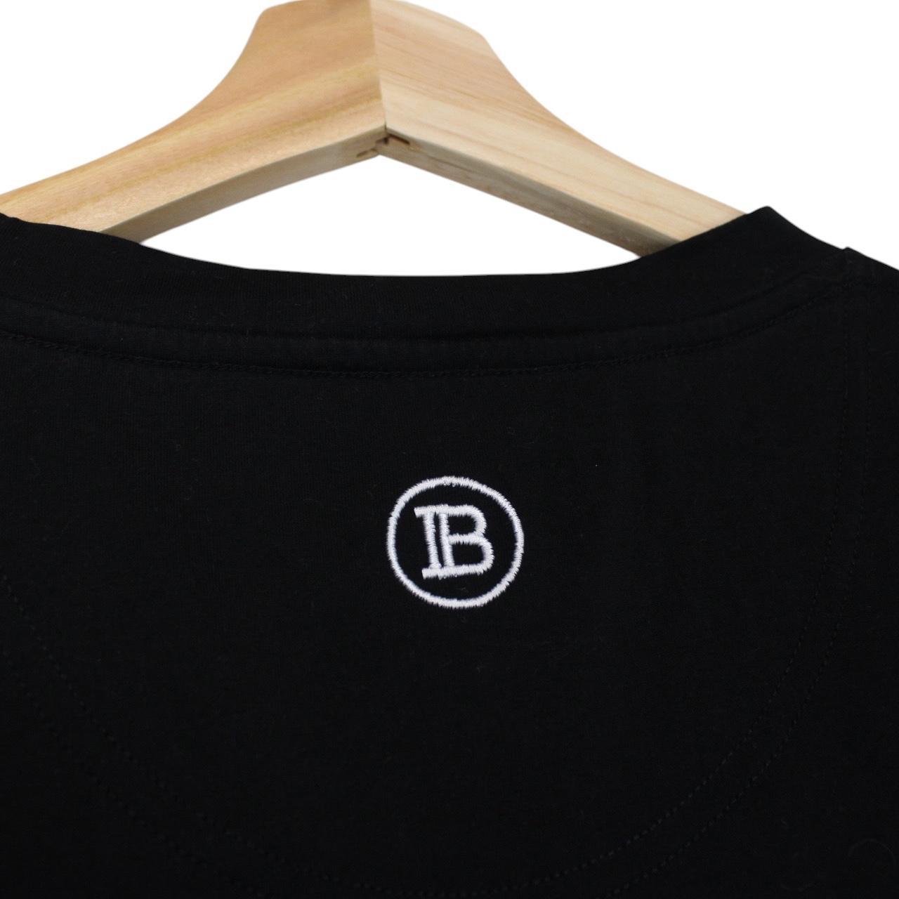 Balmain black pocket t-shirt with white embroidered logo and short sleeves.