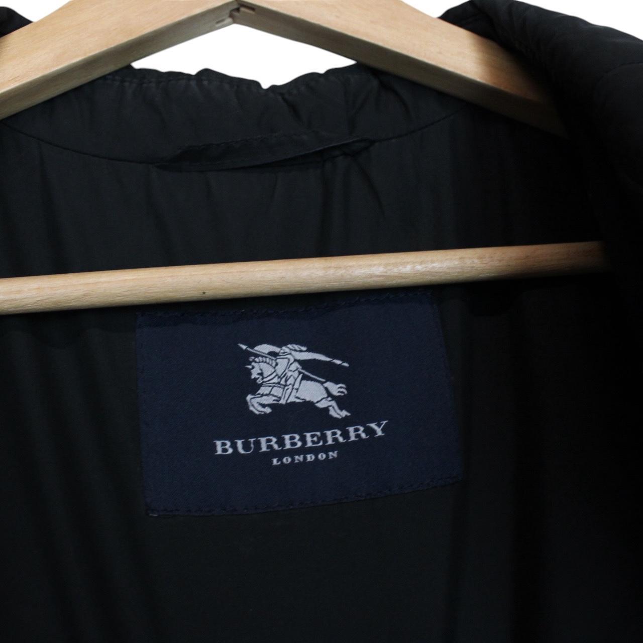 Burberry black coat with Nova Check lining and diamond quilted pattern.