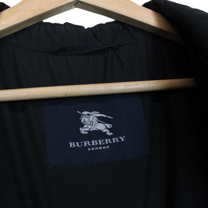 Burberry black coat with Nova Check lining and diamond quilted pattern.