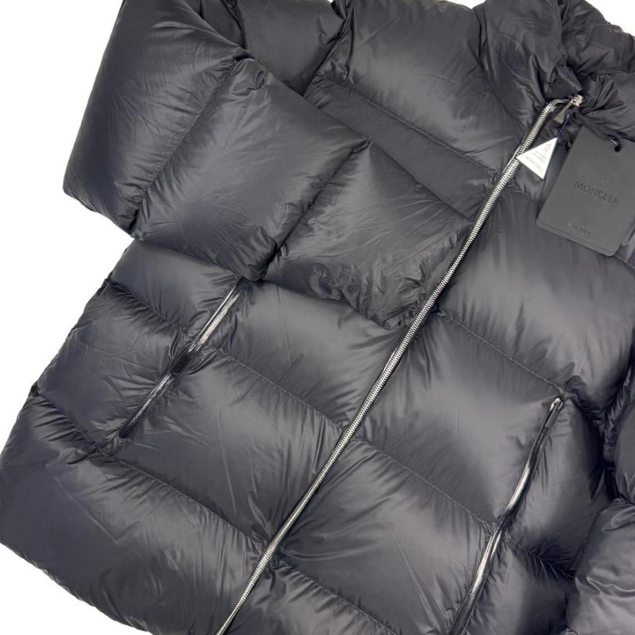 Moncler black nylon down puffer jacket with logo patch and quilted design.