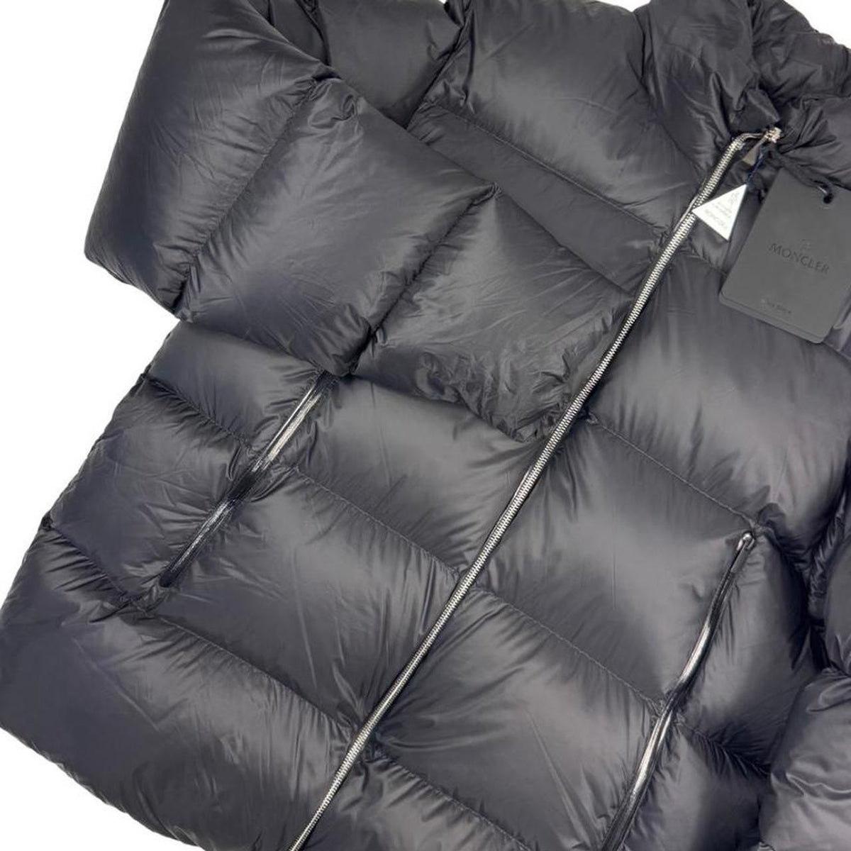 Moncler black nylon down puffer jacket with logo patch and quilted design.