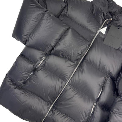 Moncler black nylon down puffer jacket with logo patch and quilted design.