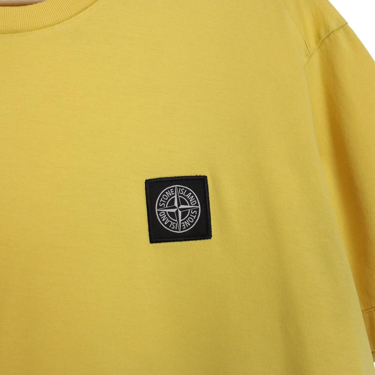 Stone Island yellow short sleeve cotton t-shirt with compass logo and soft fabric.