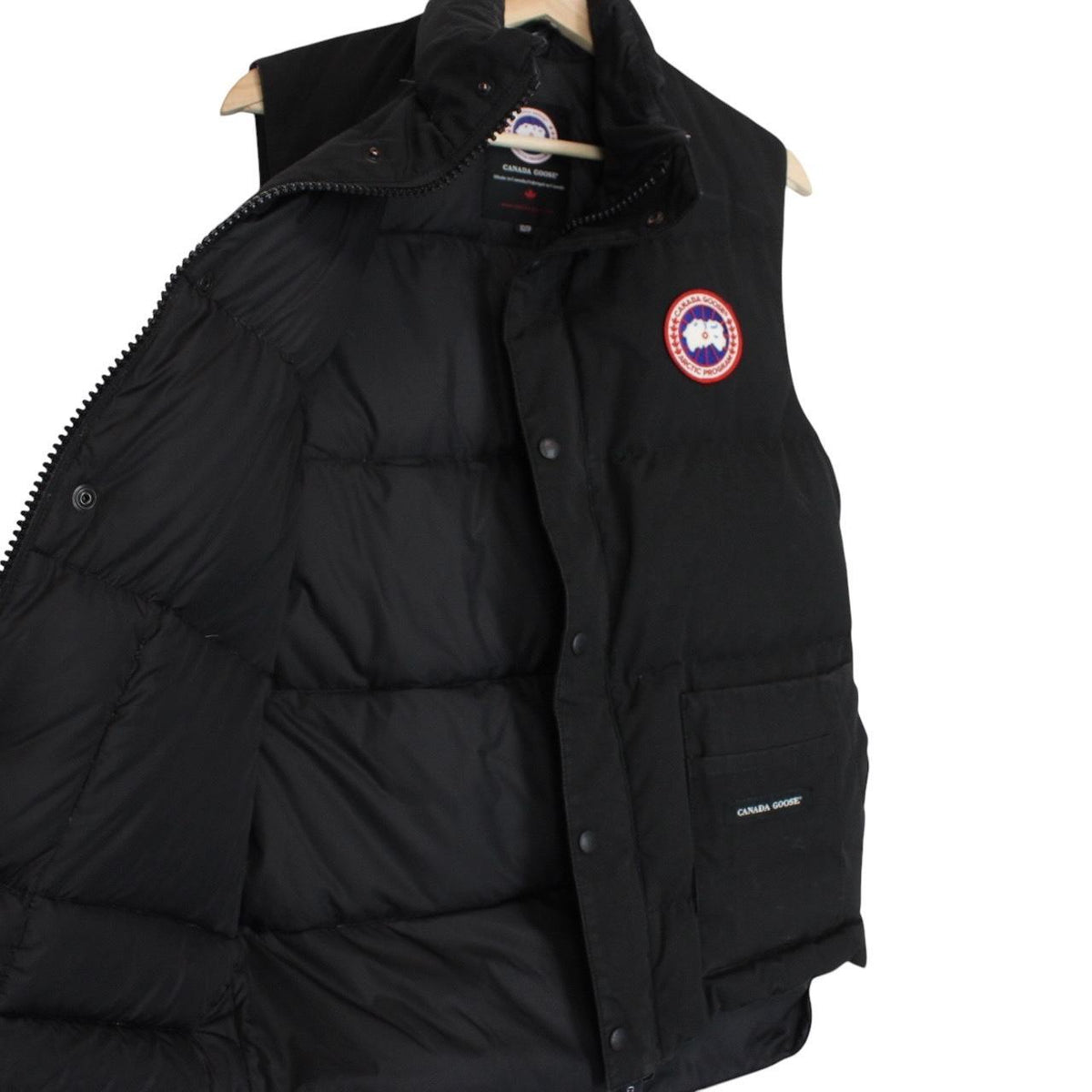 Canada Goose black down gilet with logo patch and durable exterior shell.