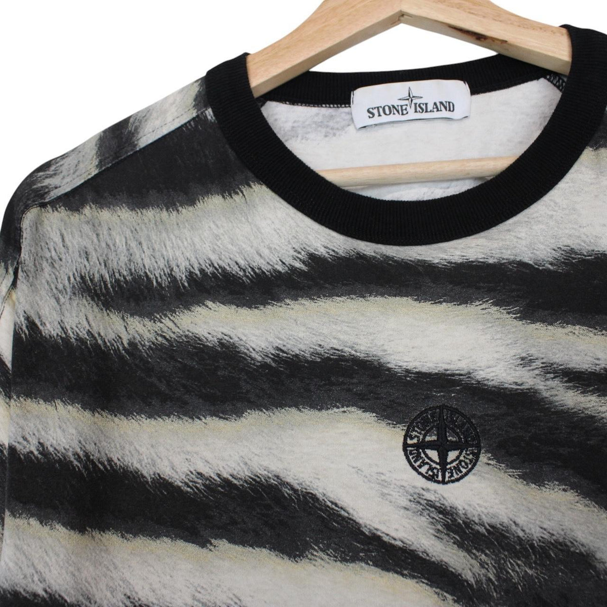 Stone Island short sleeve t-shirt in tiger camo pattern with logo patch on sleeve.