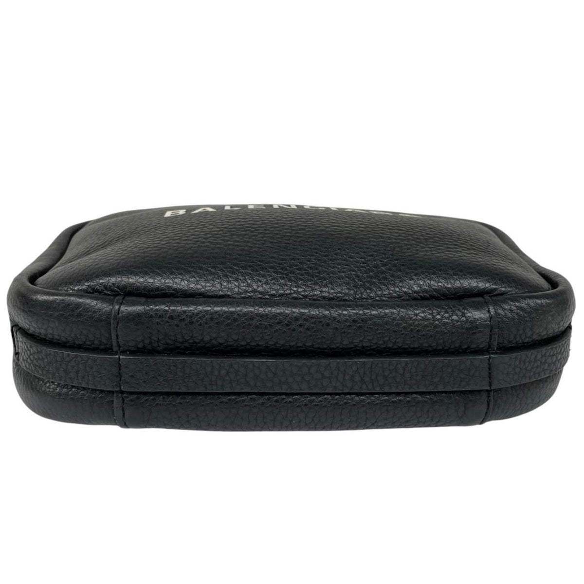Balenciaga black leather messenger bag with embossed logo and minimalistic design.