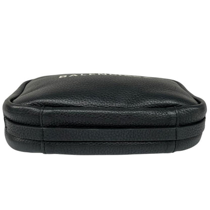 Balenciaga black leather messenger bag with embossed logo and minimalistic design.