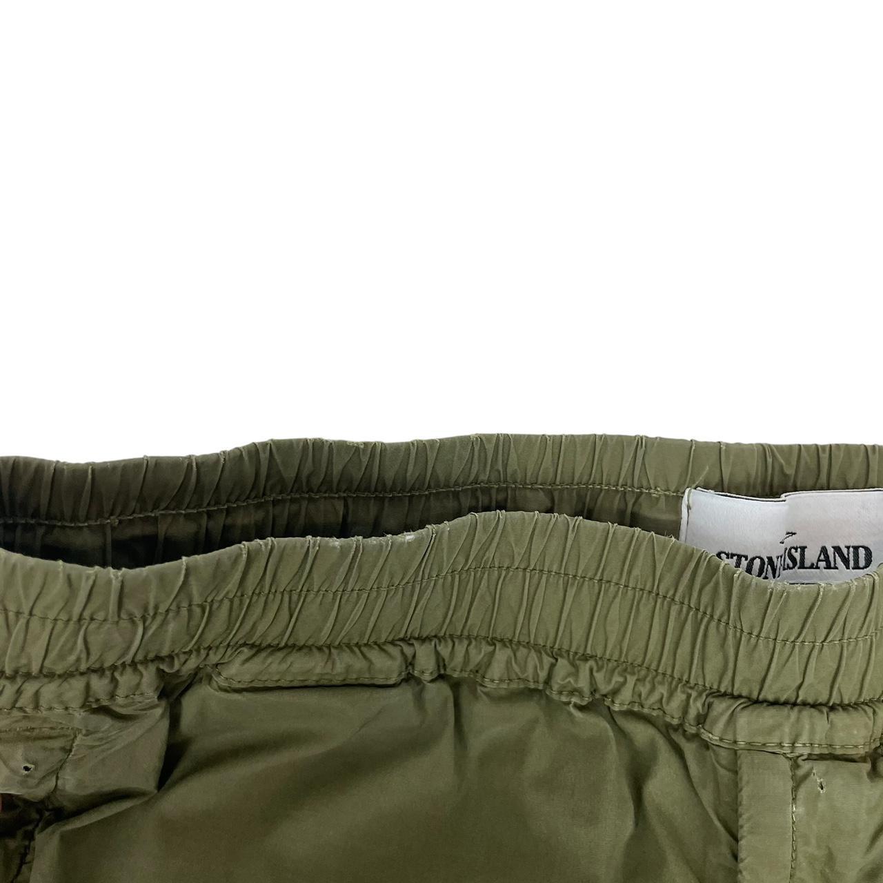 Stone Island khaki green cargo trousers with logo patch and multiple pockets.
