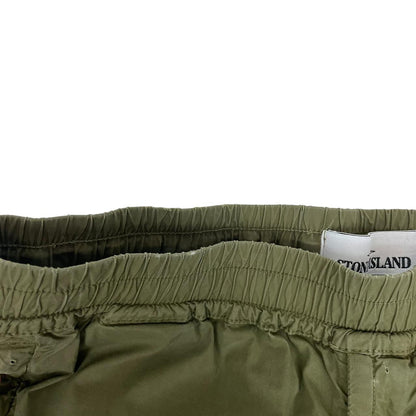 Stone Island khaki green cargo trousers with logo patch and multiple pockets.