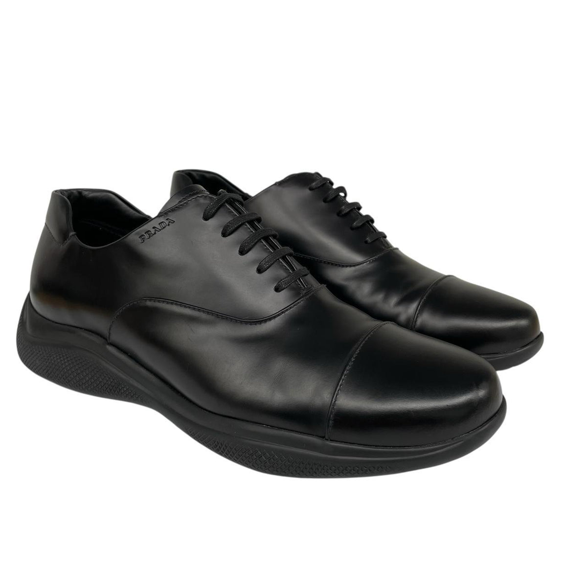 Prada black leather laced derby loafers with subtle signs of wear, includes original dust bags.