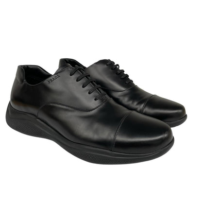 Prada black leather laced derby loafers with subtle signs of wear, includes original dust bags.