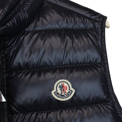 Moncler navy blue down gilet with logo patch and quilted design.