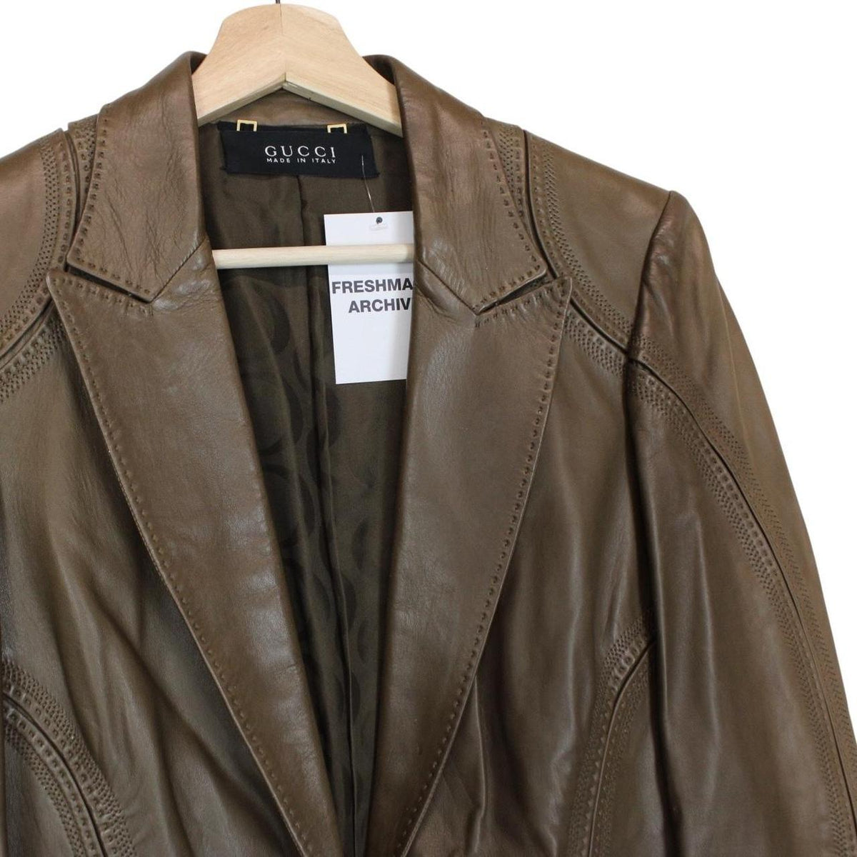 Gucci brown leather blazer jacket with logo detailing and classic tailored fit.