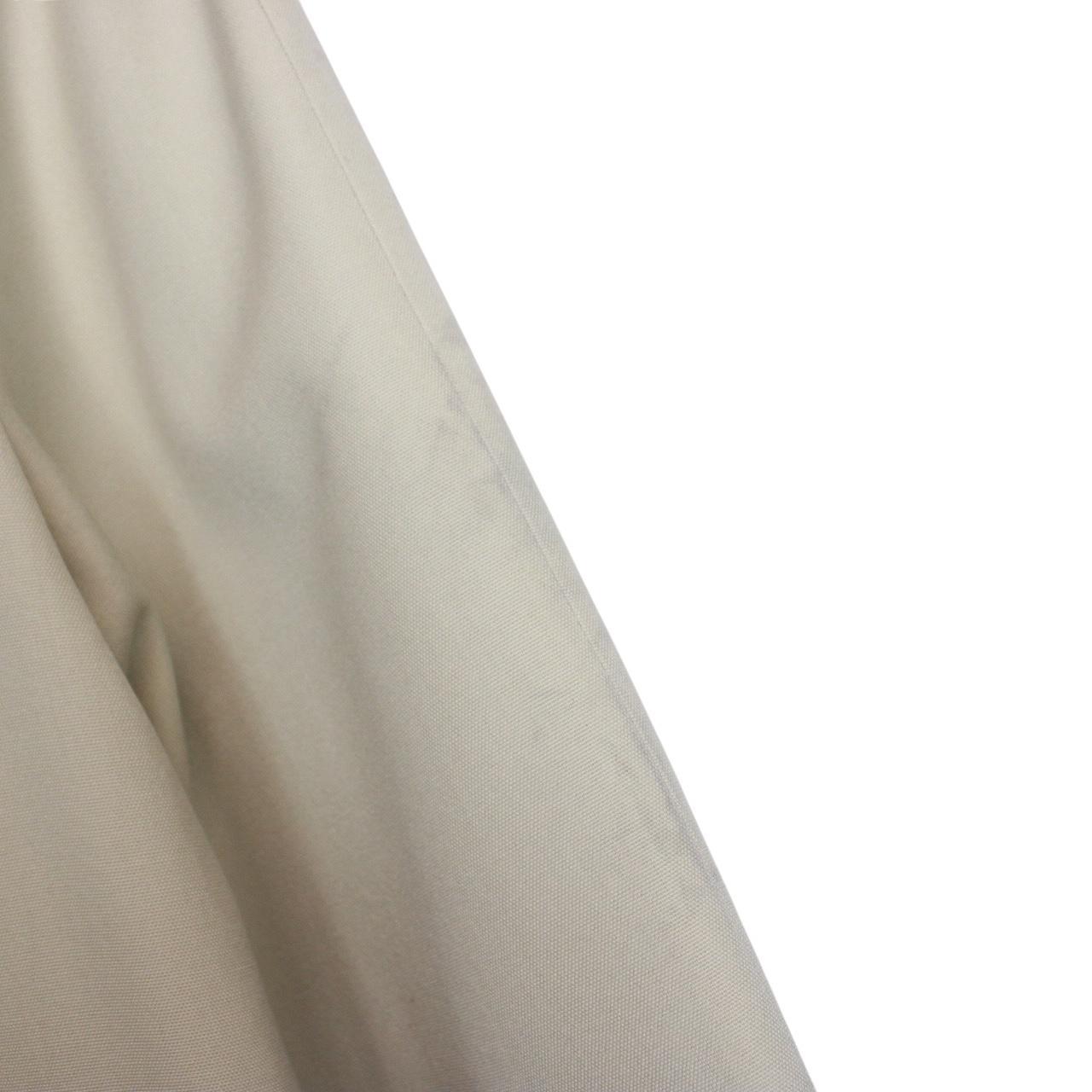 Burberry cream trench coat, single breasted, vintage 80s style, visible mark on sleeve.