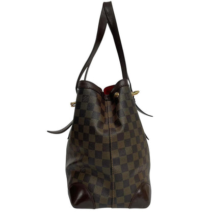 Louis Vuitton brown duffel bag with Damier Ebene pattern and logo plaque details.