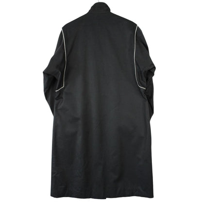 Burberry black cotton trench coat with single breasted design and classic logo detailing.