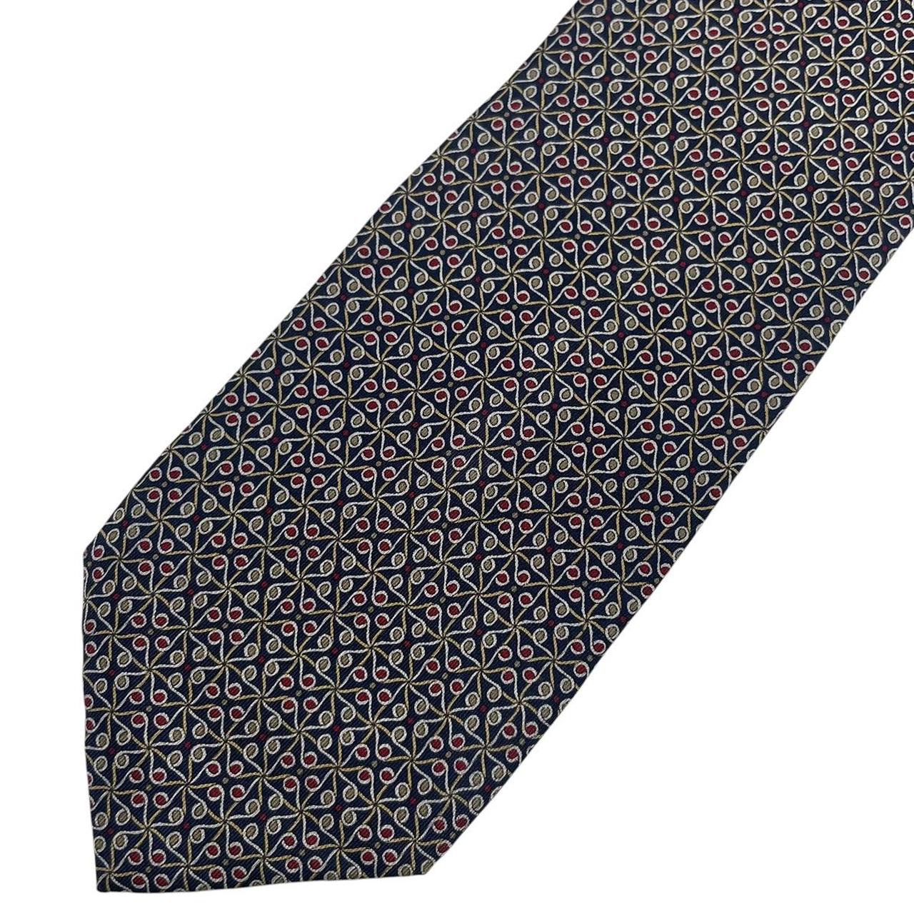 Gucci navy blue silk tie with vintage pattern and logo detail.