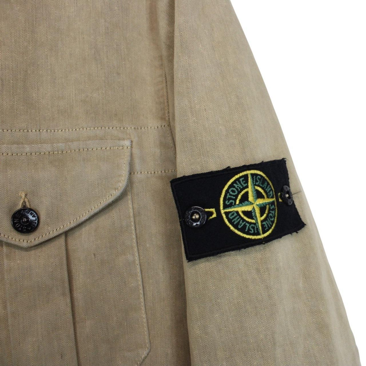 Stone Island beige multi-pocket jacket with logo patch and linen material.