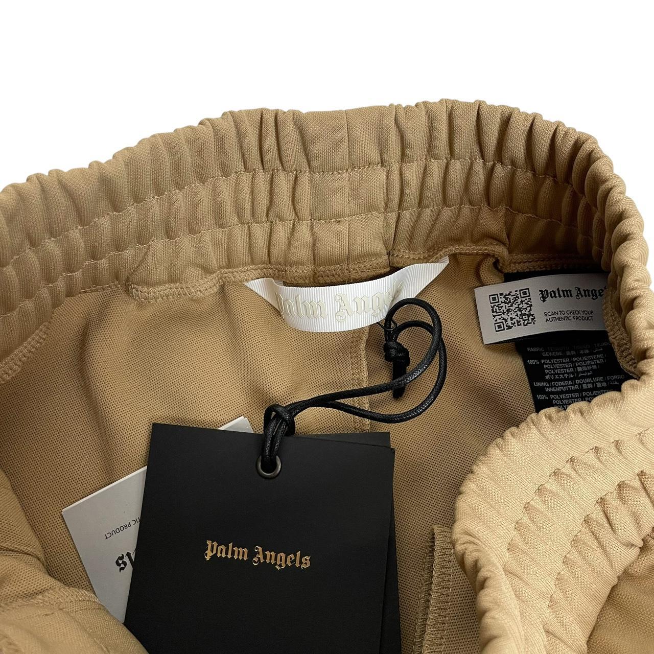 Palm Angels beige and white joggers with logo detail and classic design.