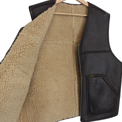 Supreme brown reversible faux shearling work vest with logo patch and textured fabric.