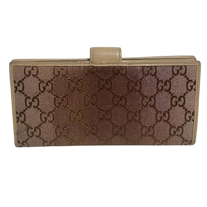 Gucci beige and pink GG monogram continental wallet with logo and wear details.