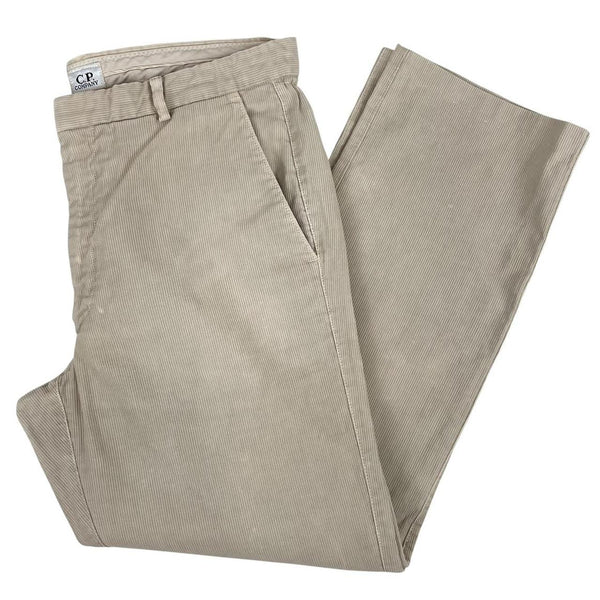 CP Company beige ribbed cotton trousers with faint stains and regular fit design.
