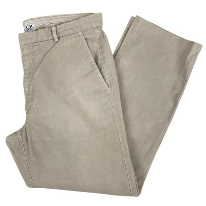 CP Company beige ribbed cotton trousers with faint stains and regular fit design.