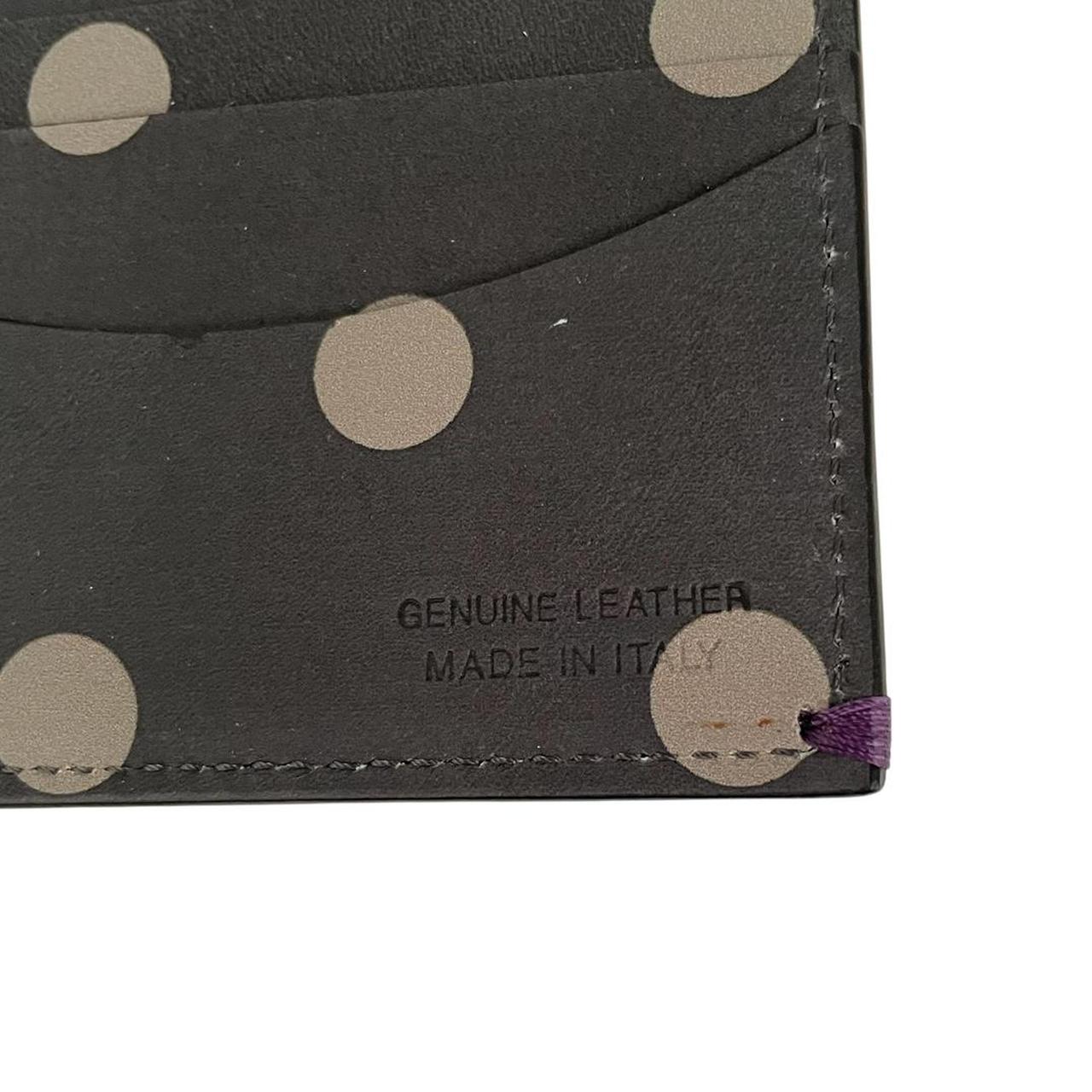 Paul Smith grey leather bifold wallet with polka dot pattern and embossed logo.