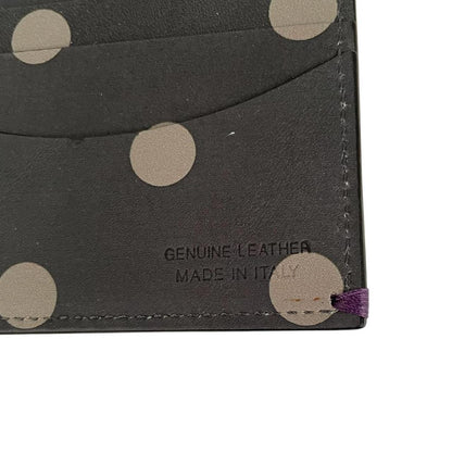 Paul Smith grey leather bifold wallet with polka dot pattern and embossed logo.