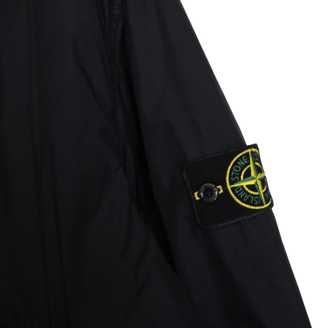 Stone Island black jacket with crinkle texture and logo patch on sleeve.