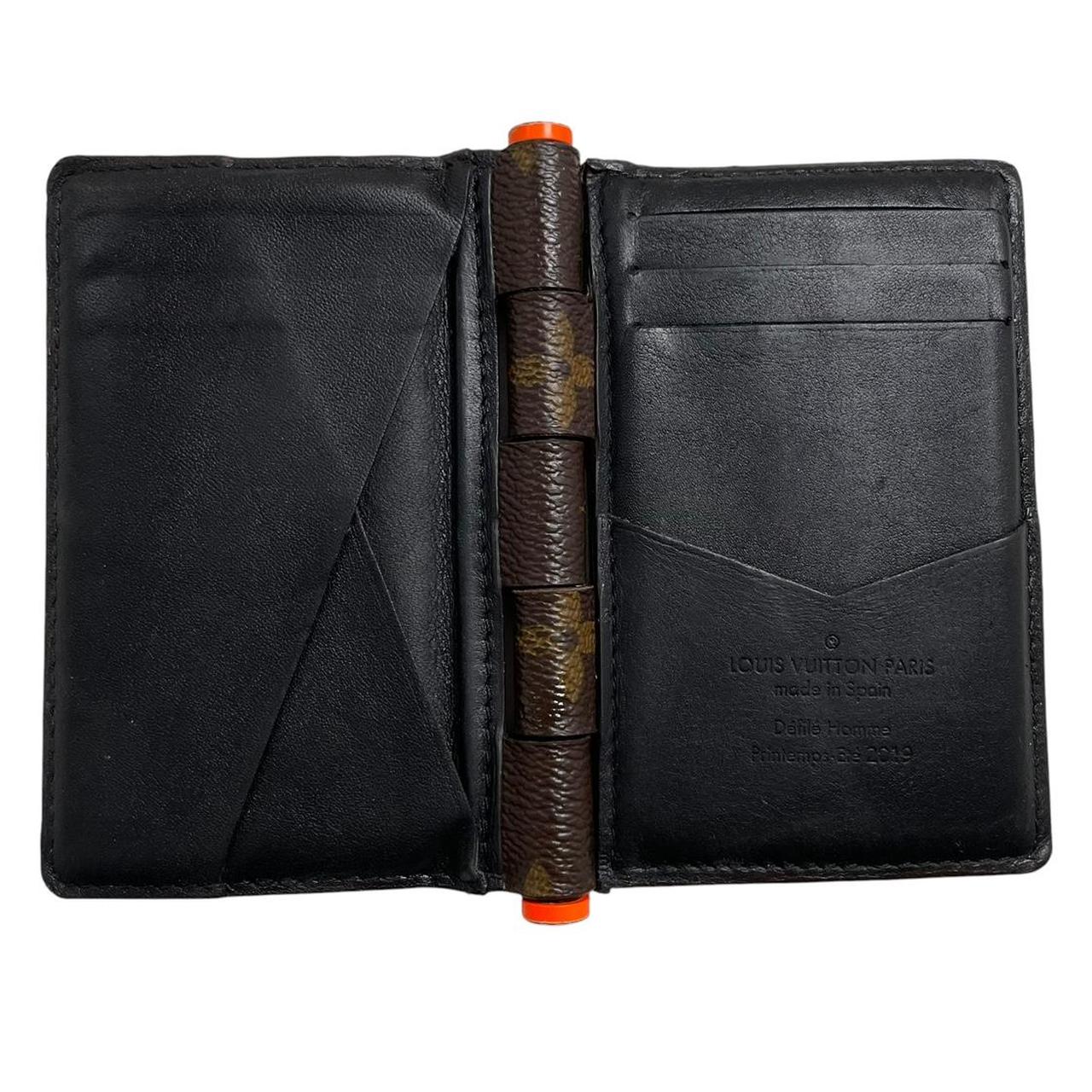 Louis Vuitton brown purse with orange metal hardware and iconic monogram pattern.