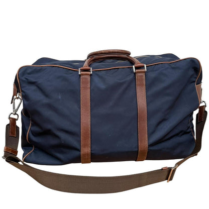 Prada navy blue and brown nylon duffel bag with signature logo and minimal wear.